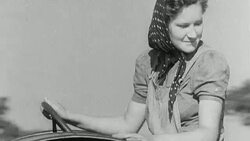 1942 MONTAGE Farmers and Land Army girls harvesting crops of grain in World War II / United Kingdom Stock Footage