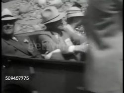 1933: U.S. PRESIDENT FDR TRAVELING: VS Franklin Roosevelt riding in convertible car, crowds. WS FDR waving from train, Native American Indians FG. Vacation, New Deal. Instructional Video