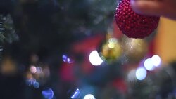 female hand hangs a Christmas ball on the Christmas tree Stock Footage
