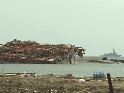 Destruction in Rikuzentakata, Iwate Prefecture, Japan on 2nd April 2011; after tsunami following Tohuku earthquake of March 2011.  This coastal town suffered severe damage with a large part of the residential area being completely flattened. Stock Footage
