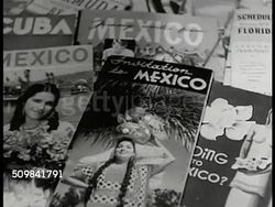 1948: U.S. MEXICO VACATION PLANNING: INT VS Family at table looking at traveling brochures. CU Mexico brochures. EXT WS Brentanos book store, NYC. MS Woman, table of books on Mexico. MS Man showing book to woman. CU Books. Instructional Video