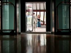 MS Middle aged couple walking into lobby of upscale hotel in urban area / Minneapolis, Minnesota, United States Stock Footage