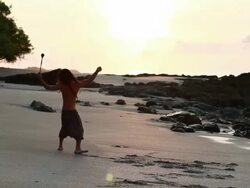 MS PAN Rasta man doing cartwheels spinning poi balls on beach with ocean / Montezuma, Punteranes, Costa Rica Stock Footage