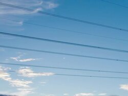 Time lapse pan of electrical lines and pylon at sunset Stock Footage