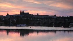 The buildings in the Castle District of Prague reflect on the surface of the Vltava River. Stock Footage