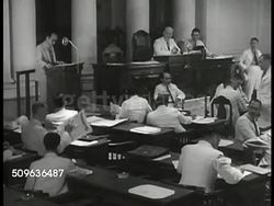 1940: EAST INDIES PEOPLE IN GOVERNMENT: WS Columned building used for government, INT Building w/ Dutch & Indonesian people government meeting, similar to parliament. Colonial rule. Instructional Video