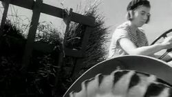 1942 MONTAGE Volunteers from the city and the armed forces volunteering and harvesting grain on a farm during World War II / United Kingdom Stock Footage