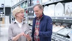 Senior couple buying a water-tap Stock Footage