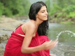 Woman playing at riverbank, Malshej Ghat, Maharashtra, India Stock Footage