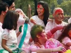 Family celebrating holi festival in the lawn  Stock Footage