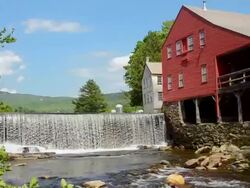 MS PAN Shot of Weston Vermont river old mill and barn by water / Weston, Vermont, United States Stock Footage