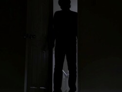 Silhouette of a man entering a dark room. Stock Footage