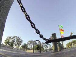 Skateboarder doing an ollie over chains. Stock Footage