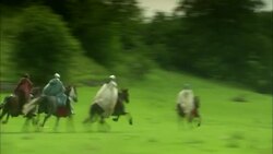 Four medieval soldiers riding horses through countryside Stock Footage