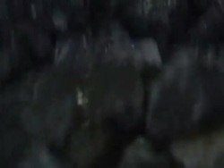 Close Up static - A gyrating conveyor transports coal. Stock Footage