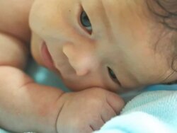Baby lie prone on blue towel Stock Footage