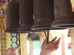 Woman rings a temple bell Stock Footage