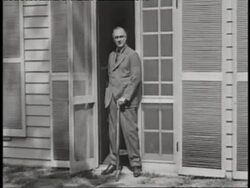 Franklin D. Roosevelt stands with a cane in a doorway. News Clip