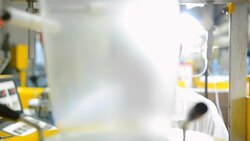 panning: senior scienctist behind extruder machine Stock Footage