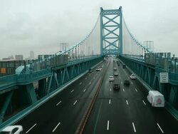 Time lapse, overhead traffic crosses Ben Franklin Bridge during rain storm. Stock Footage