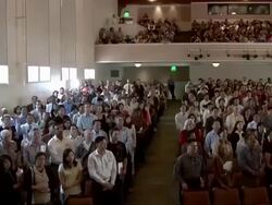 New US citizens take oath as group in auditorium  Stock Footage