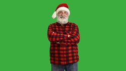 adult senior beard man crosses his arms in a hat santa claus  on a green background Stock Footage