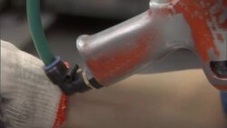 An assembly line worker uses an electric screwdriver. Stock Footage