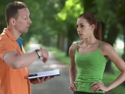 HD DOLLY: Coach Timing Female Runner Stock Footage