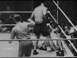 1927: BOXING: Headlines 'Tunney Win', SLO MO Former champion Jack Dempsey boxing in ring fight w/ Heavyweight Champion Gene Tunney, Dempsey knocking Tunney down, referee slow to count, VO 'The Long Count', Tunney jumping up at nine, fighting. Instructional Video