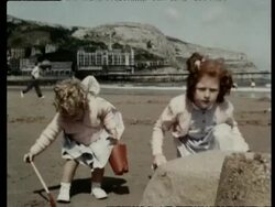 The seaside resort of Llandudno in Conwy, North Wales. Children making sandcastles, donkey rides, fishermen carrying nets, 1957 Stock Footage