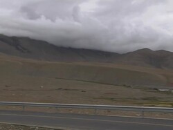 Pan Right Highway with hills and clouds Taklakot Tibet China Stock Footage