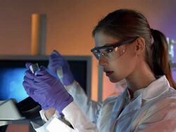 HD DOLLY: Female Scientist Preparing Microscope Slide Stock Footage