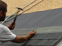MS Shot of worker hammering  on roof of red building / Chelsea, Michigan, United States Stock Footage