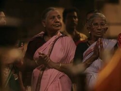 MS Women wearing saris and clapping, incense burning in foreground / Varanasi, India Stock Footage