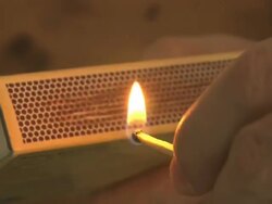 Close Up tracking-left - A hand strikes a match on a matchbox. / Sweden Stock Footage