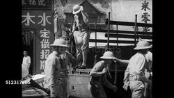 1939: U.S. MARINES IN CHINA: CU Plaque 'HQ Marines.' WS Marines getting off truck. WS Soldier guarding entrance to power company. WS Soldiers marching down street Chinese men watching. MS Guard on patrol sign 'No Admittance Shanghai Power Company.' Instructional Video
