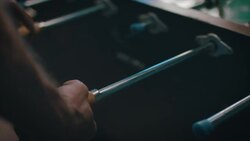 Guys playing tabletop soccer in apartment Stock Footage