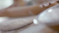 Baker flattens dough with rolling pin Stock Footage