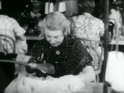 B/W 1934 blonde woman using sewing machine in WPA garment factory / documentary Stock Footage