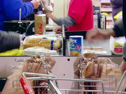 CU Shot of people in supermarket at cashier's desk packing things in bags / Minneapolis, Minnesota, United States Stock Footage