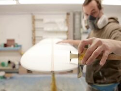 MS Shaper marking up surfboard ready for resin / Wadebridge, Cornwall, United Kingdom Stock Footage