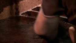 A tile worker smooths clay as it pours into molds. Stock Footage