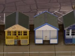 Aerial low over row of colorful beach huts / Southwold, Suffolk, England Stock Footage