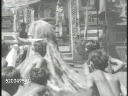 c1950: SOUTH PACIFIC ASIAN DANCE: VS Various South Pacific Asian male dancers dancing during outdoor show, fending off another dancer in costume (spirit, monster). Native dance, indigenous people, tradition, culture, music Instructional Video