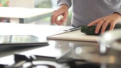 Female in kitchen preparing food and look at digital tablet Stock Footage