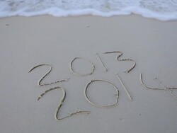 â€œ2014" word written on the sand Stock Footage