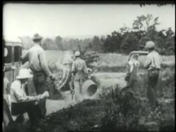 A homeless family stands on the side of a dusty road. News Clip