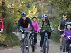 TS Parents and Children Riding Bikes Together on Path in Woods / Richmond, Virginia, USA Stock Footage