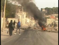 POV from car, Aftermath of fire bomb, scattered debris, photographers taking pictures, locals going about their business, Jerusalem Stock Footage