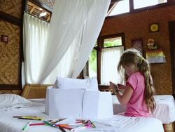 MS Shot of young girl working on art project in her bedroom / Ubud, Bali, Indonesia Stock Footage